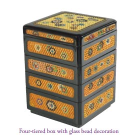 Four-tiered box with glass bead decoration